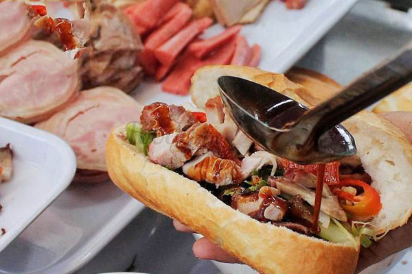 Grilled meats, cold cuts, fresh herbs and pickled veggie add up a savory taste to Banh Mi