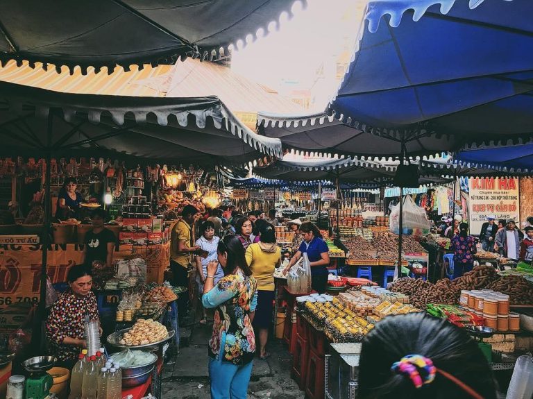 Stalls offering fresh fruits, vegetables, and street food on Hang Bo