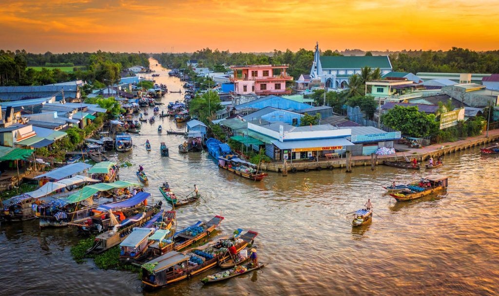 People commute by boat, bamboo bridges link the banks, floating houses rest gently on the water