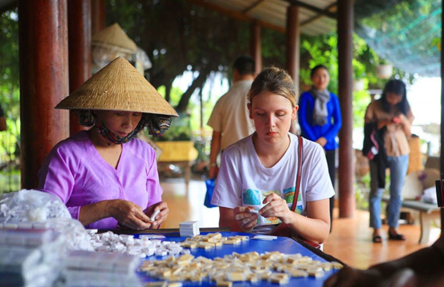 Visit small family run workshops to watch the production of fresh coconut candy (kẹo dừa) from scratch