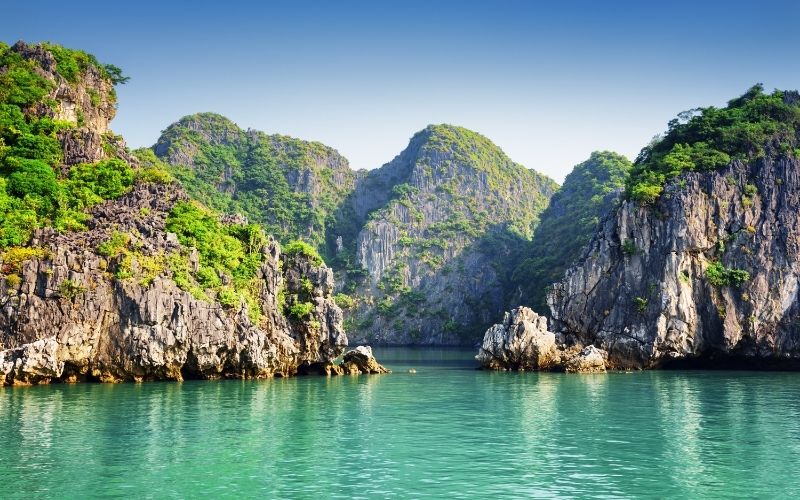 Slow down on the water and take in the limestone islands rising around the cruise