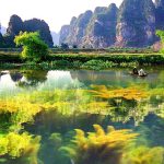 Ninh Binh, often called "Halong Bay on land", where you will take a peaceful sampan ride through winding rivers flanked