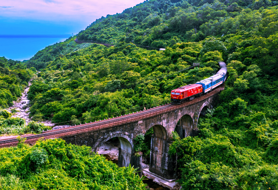 Traverse panoramic mountain passes like the legendary Hai Van Pass, where lush green jungles meet crashing ocean surf and vibrant modern coastal cities